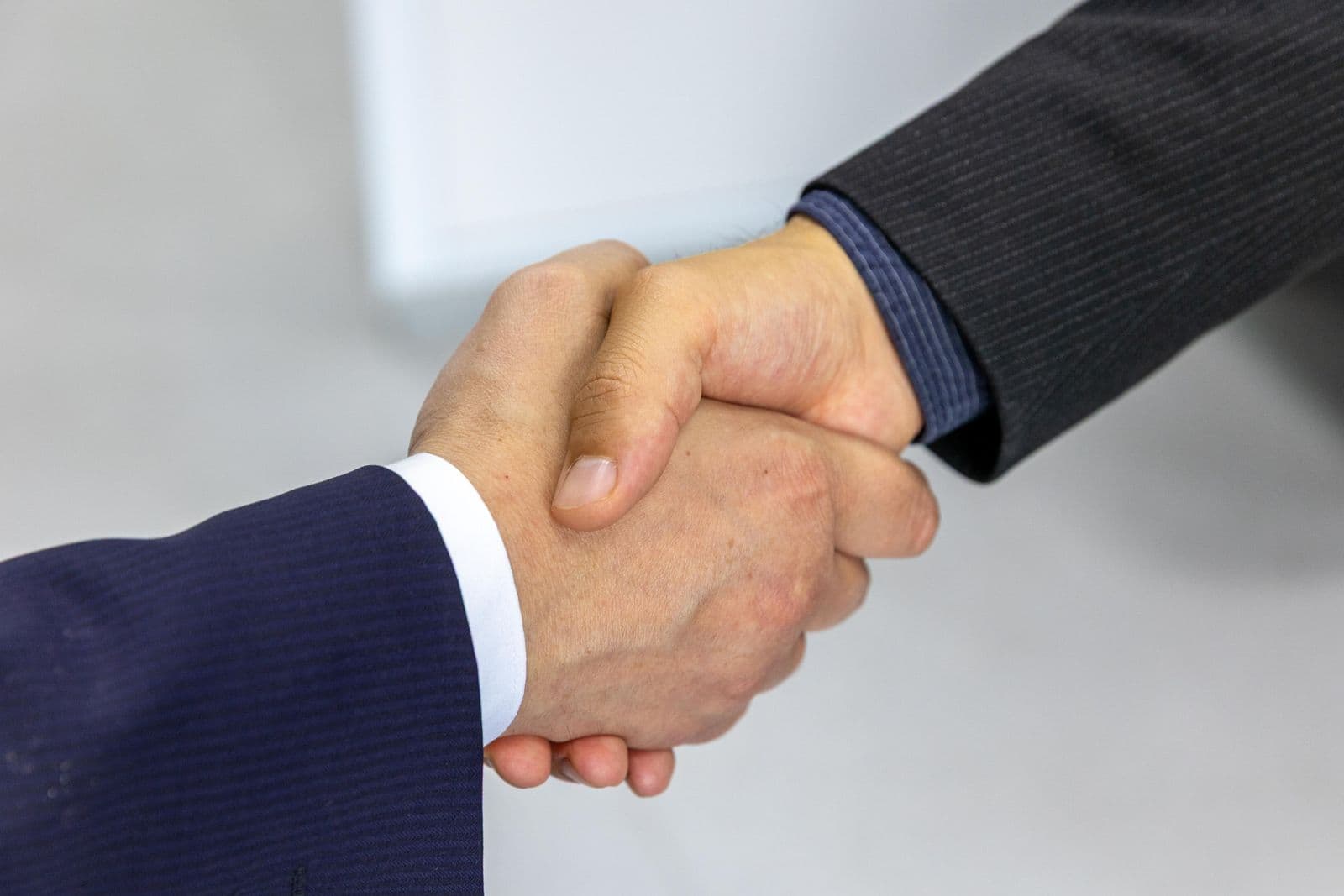 Lawyer and client sealing a consultation with a friendly handshake